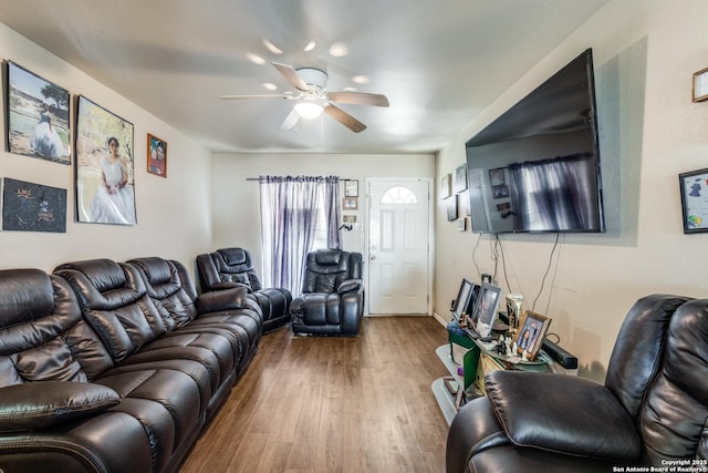 living area featuring ceiling fan and wood finished floors