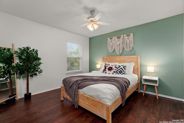 bedroom with ceiling fan, baseboards, and wood finished floors