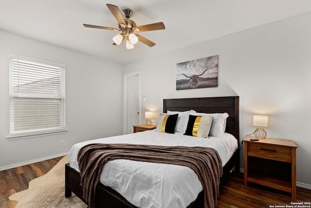 bedroom featuring ceiling fan, baseboards, and wood finished floors