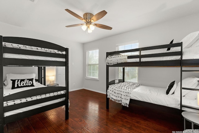 bedroom with a ceiling fan, baseboards, and hardwood / wood-style flooring