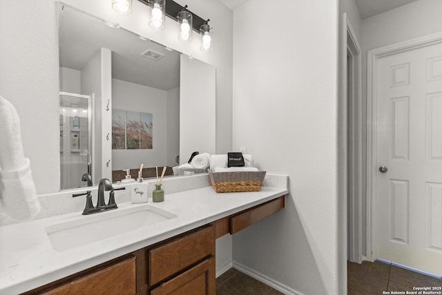 bathroom featuring visible vents, tile patterned flooring, a shower stall, and vanity