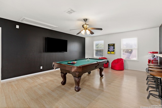 recreation room featuring a ceiling fan, attic access, visible vents, and wood finished floors