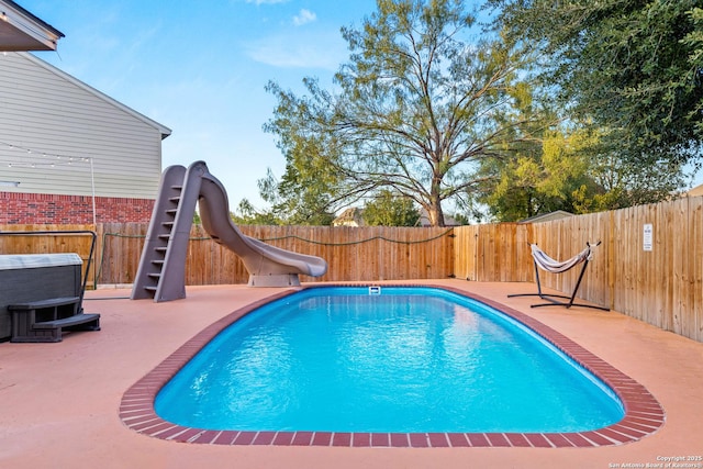 view of pool featuring a water slide, a patio area, a fenced backyard, and a fenced in pool