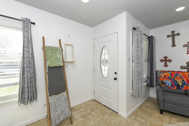 foyer with light tile patterned floors, baseboards, and recessed lighting