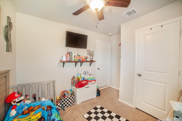 bedroom with a ceiling fan, baseboards, visible vents, and carpet flooring