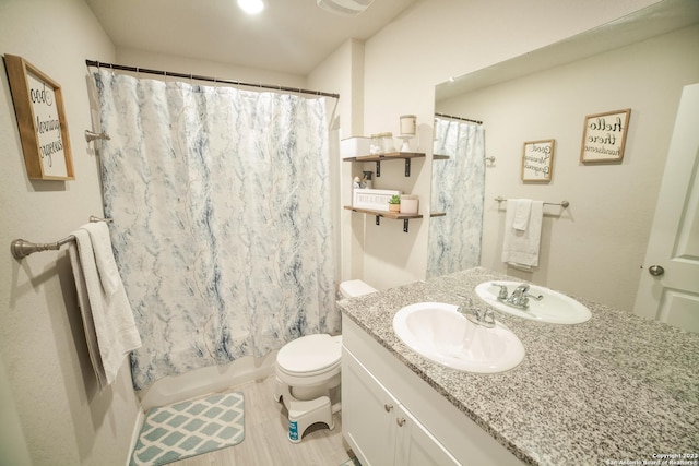 full bathroom featuring toilet, shower / bath combination with curtain, and vanity