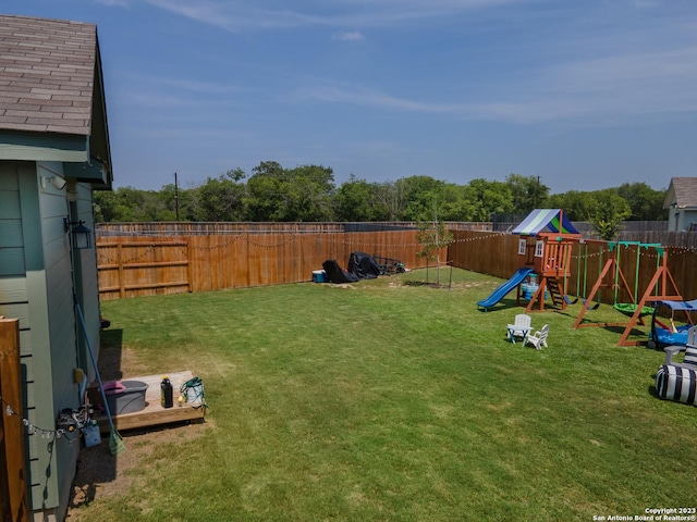 view of yard featuring a playground and a fenced backyard