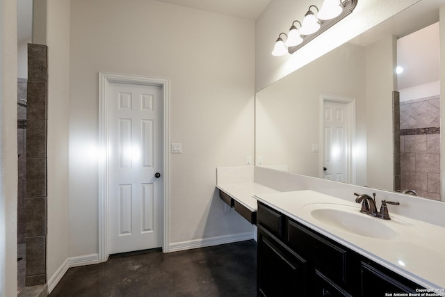 bathroom featuring concrete floors, vanity, and baseboards