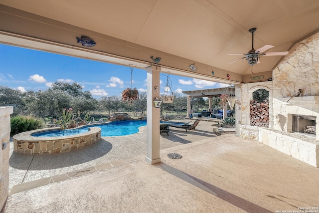 view of patio / terrace with ceiling fan, an outdoor stone fireplace, and an outdoor pool