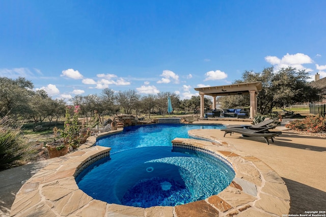 outdoor pool with a patio and an in ground hot tub