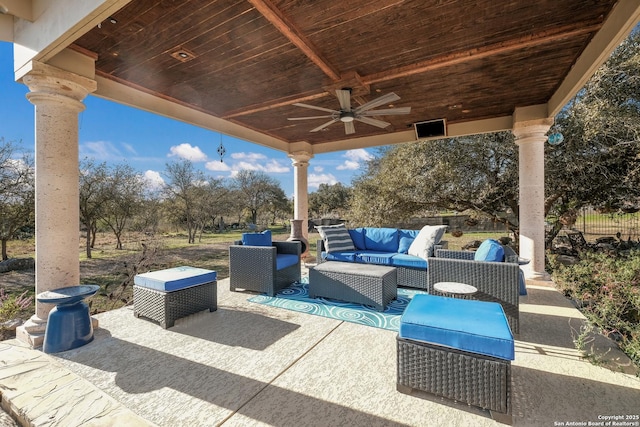 view of patio / terrace featuring ceiling fan, an outdoor living space, and fence