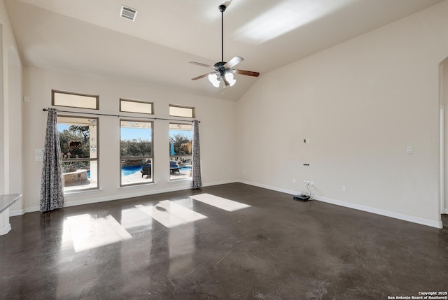 empty room featuring finished concrete floors, visible vents, vaulted ceiling, and baseboards