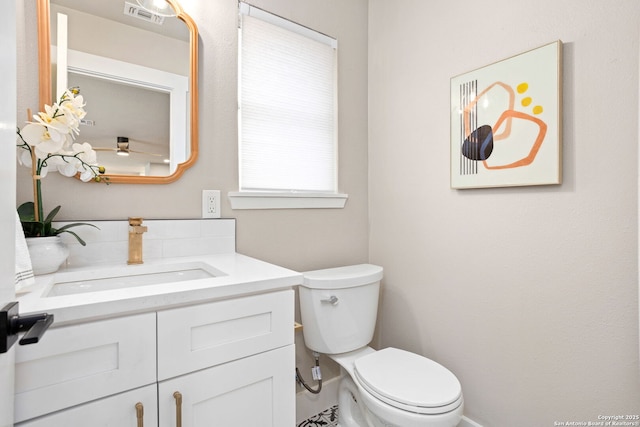 bathroom featuring toilet, visible vents, and vanity