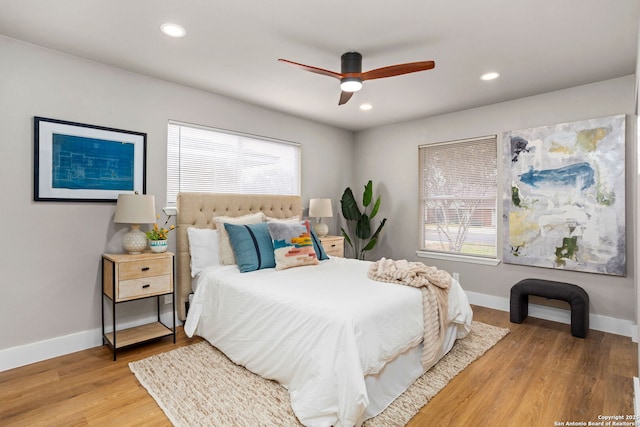 bedroom with light wood-type flooring, multiple windows, and recessed lighting