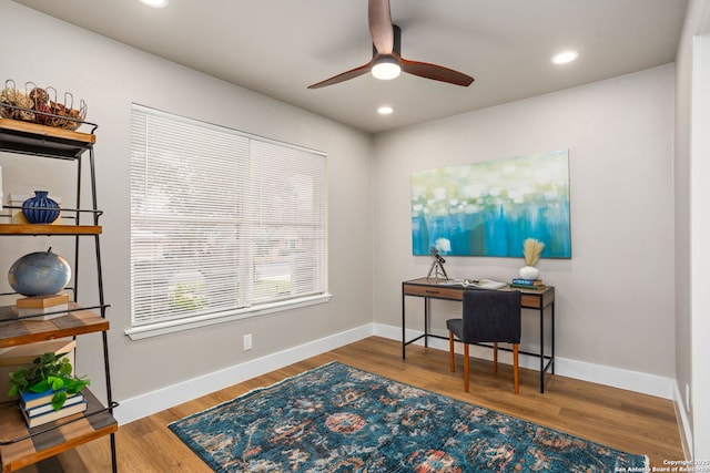 home office featuring baseboards, wood finished floors, and recessed lighting