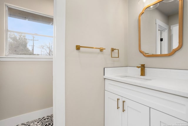 bathroom featuring baseboards and vanity