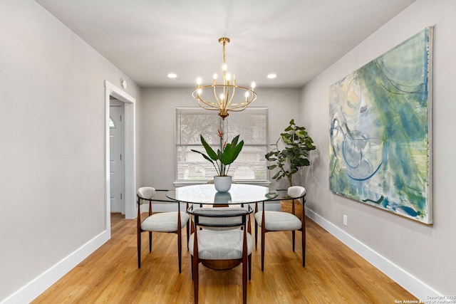 dining space with light wood-style floors, baseboards, a chandelier, and recessed lighting