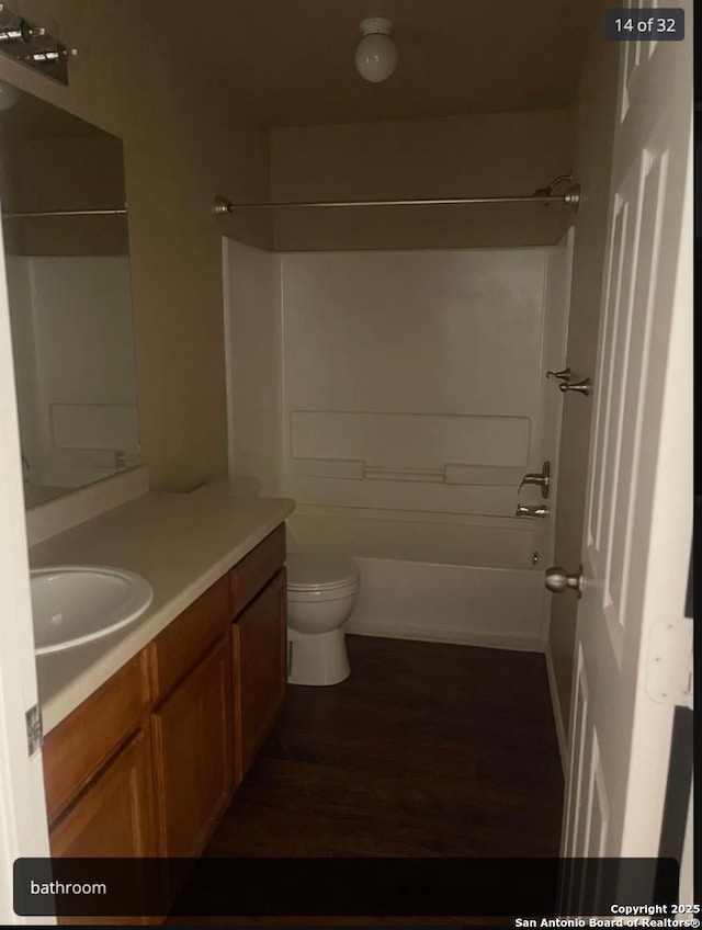 full bathroom featuring washtub / shower combination, vanity, toilet, and wood finished floors