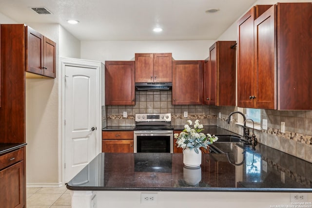 kitchen featuring backsplash, light tile patterned flooring, a sink, under cabinet range hood, and stainless steel electric range