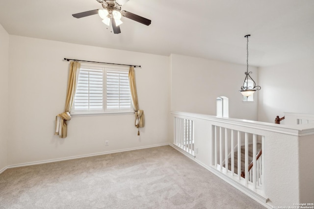 carpeted empty room featuring baseboards