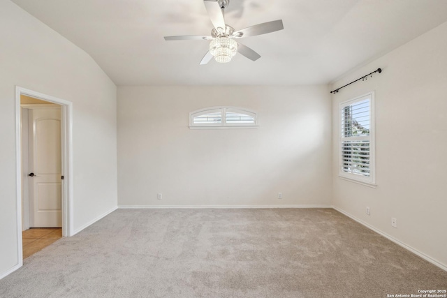 carpeted empty room featuring a ceiling fan, a healthy amount of sunlight, and baseboards