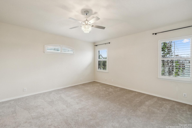 empty room featuring carpet floors, ceiling fan, and baseboards