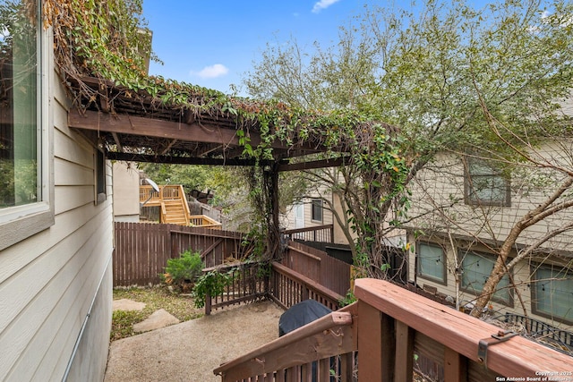 wooden terrace featuring fence