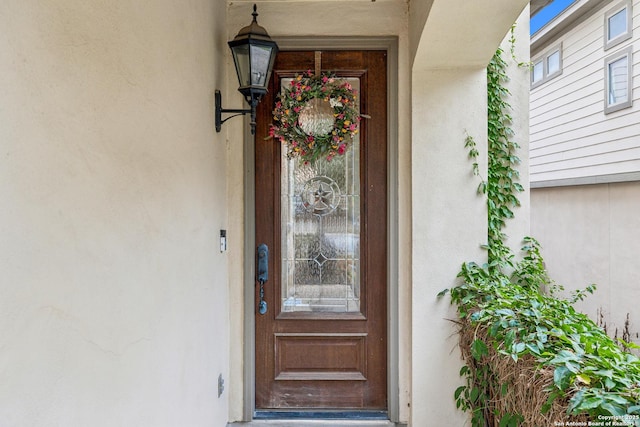 doorway to property with stucco siding