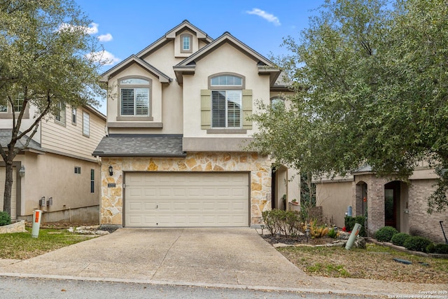 view of front of property with stone siding, an attached garage, concrete driveway, and stucco siding