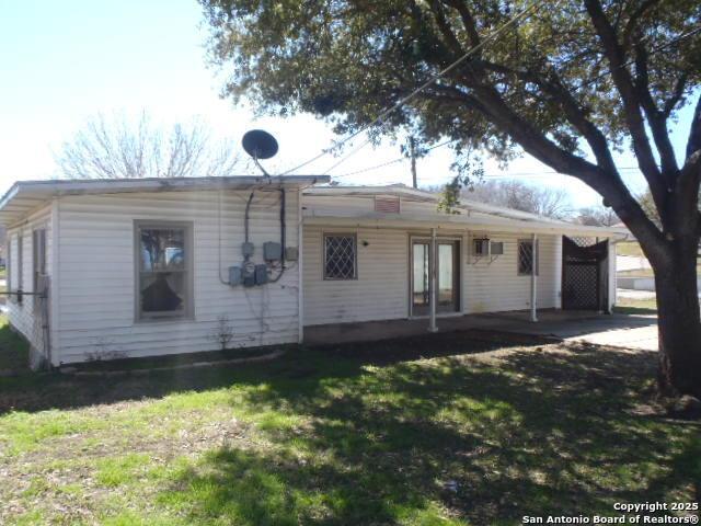 rear view of house featuring a yard and french doors