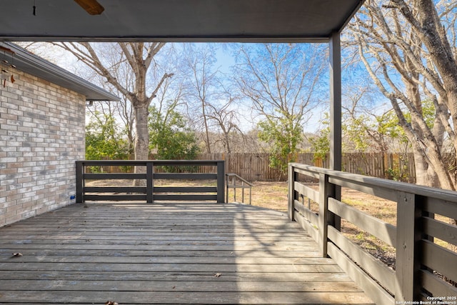 wooden terrace featuring a fenced backyard and ceiling fan