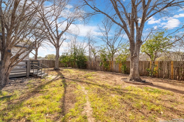 view of yard featuring a fenced backyard and a deck