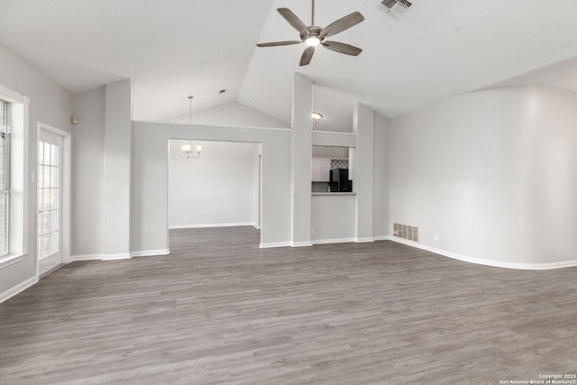 unfurnished living room with lofted ceiling, visible vents, and wood finished floors