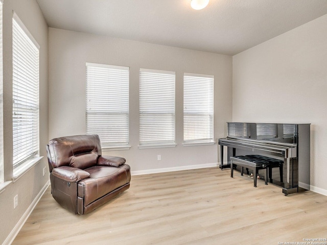 sitting room featuring light wood finished floors and baseboards