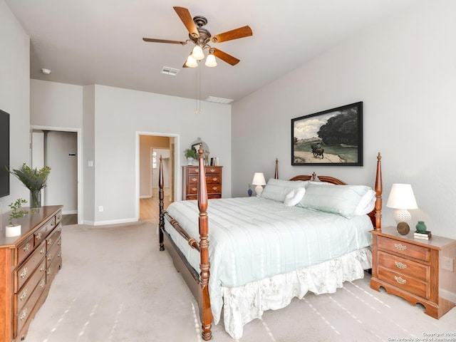 bedroom with light carpet, ceiling fan, visible vents, and baseboards