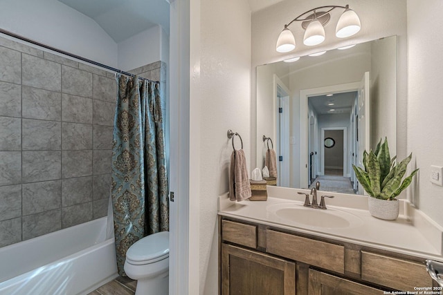 bathroom with shower / tub combo with curtain, vanity, and toilet