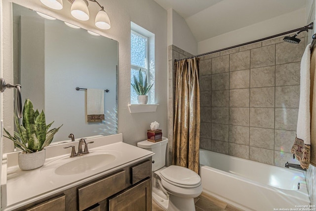 bathroom featuring lofted ceiling, vanity, toilet, and shower / tub combo with curtain