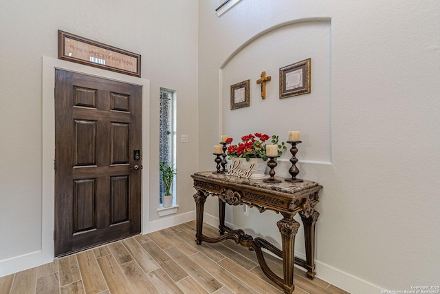 entrance foyer featuring wood finish floors and baseboards