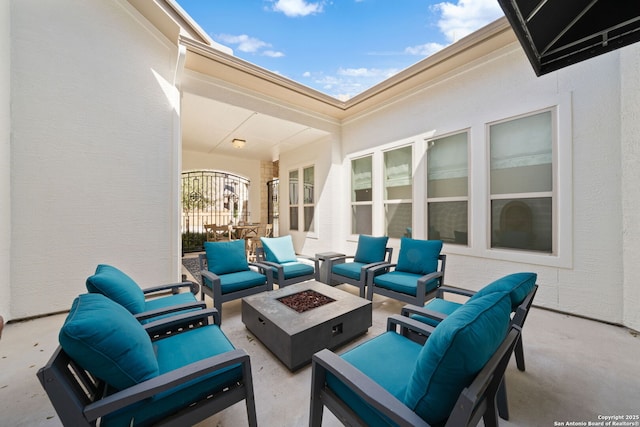 view of patio featuring an outdoor living space with a fire pit