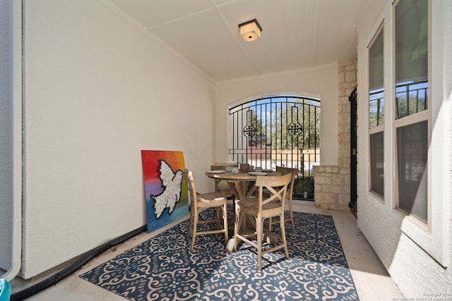 dining area with concrete flooring and crown molding