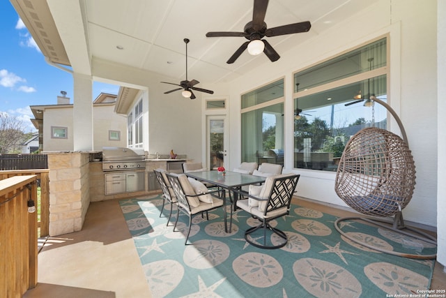 view of patio / terrace with ceiling fan, a grill, outdoor dining area, and exterior kitchen