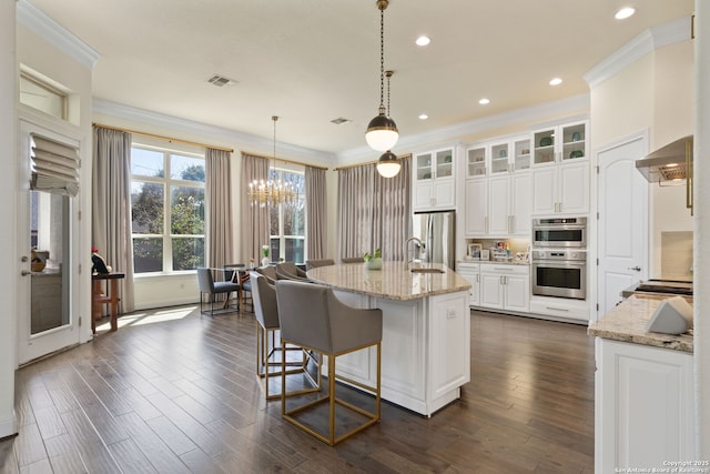 kitchen with visible vents, dark wood-style floors, appliances with stainless steel finishes, ornamental molding, and a sink