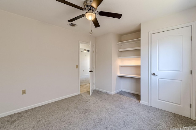 unfurnished bedroom featuring a ceiling fan, baseboards, visible vents, and carpet flooring