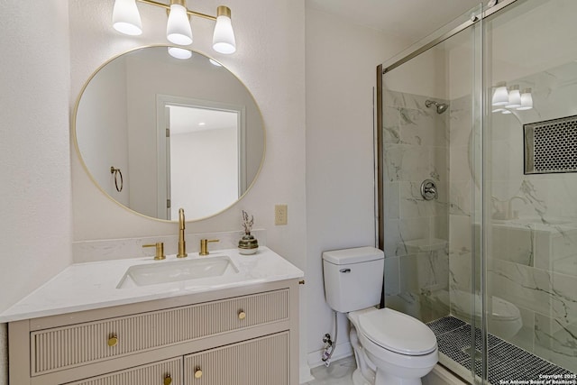 bathroom featuring toilet, a stall shower, and vanity