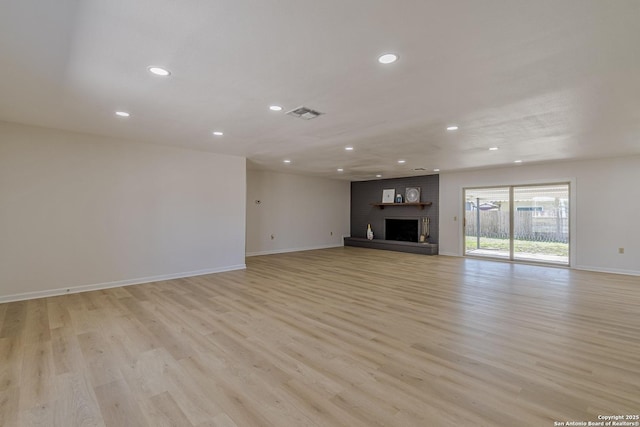 unfurnished living room featuring light wood-type flooring, a fireplace, visible vents, and recessed lighting