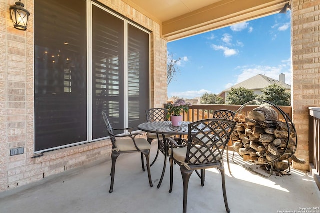 balcony featuring outdoor dining space and a sunroom