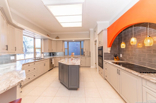 kitchen featuring light tile patterned floors, light stone counters, crown molding, black appliances, and a sink