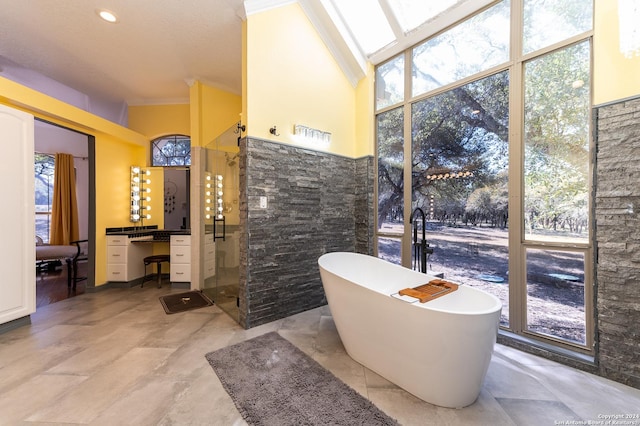 full bath with a freestanding bath, ornamental molding, and a shower stall