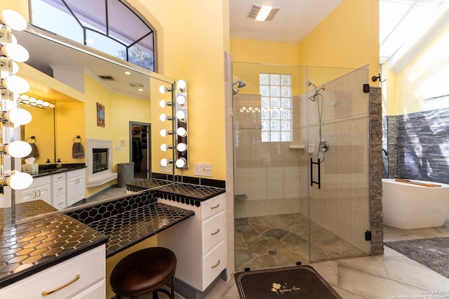 bathroom with a wealth of natural light, a stall shower, vanity, and visible vents