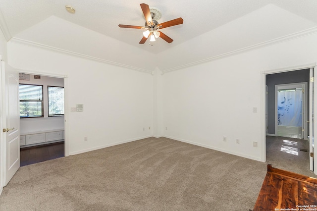 unfurnished room featuring carpet floors, crown molding, lofted ceiling, ceiling fan, and baseboards